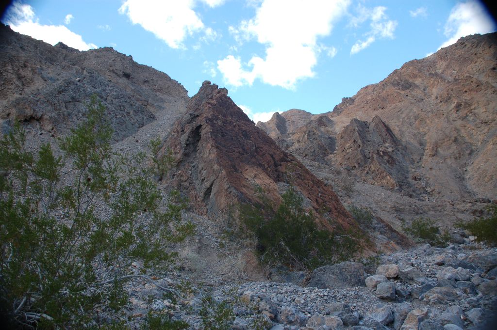 A triangular rock with a flat face off to the left: